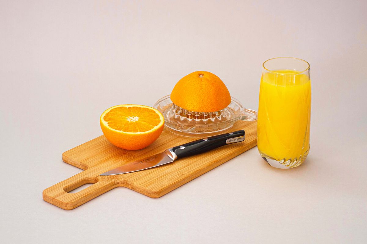 Orange slices beside a cosmetic bottle